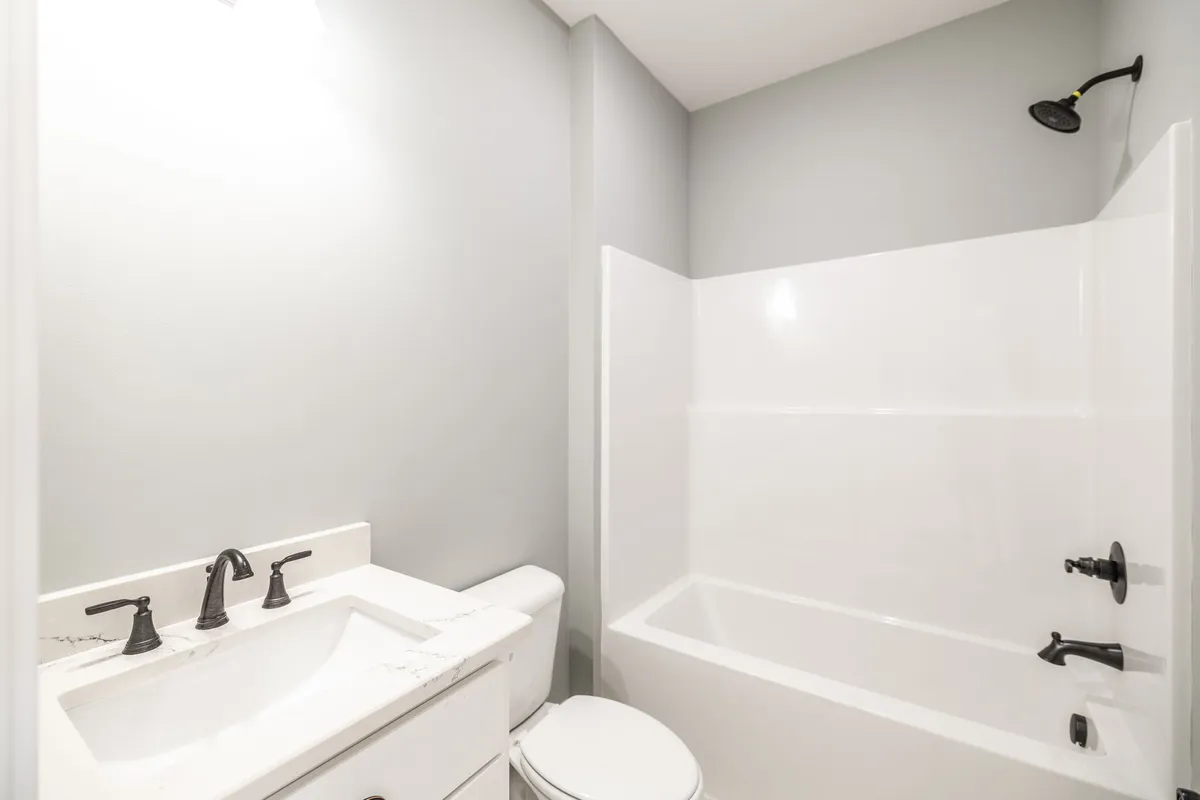 Second full bathroom with a tub-shower combo and double vanity at 1200 Vickie Ln