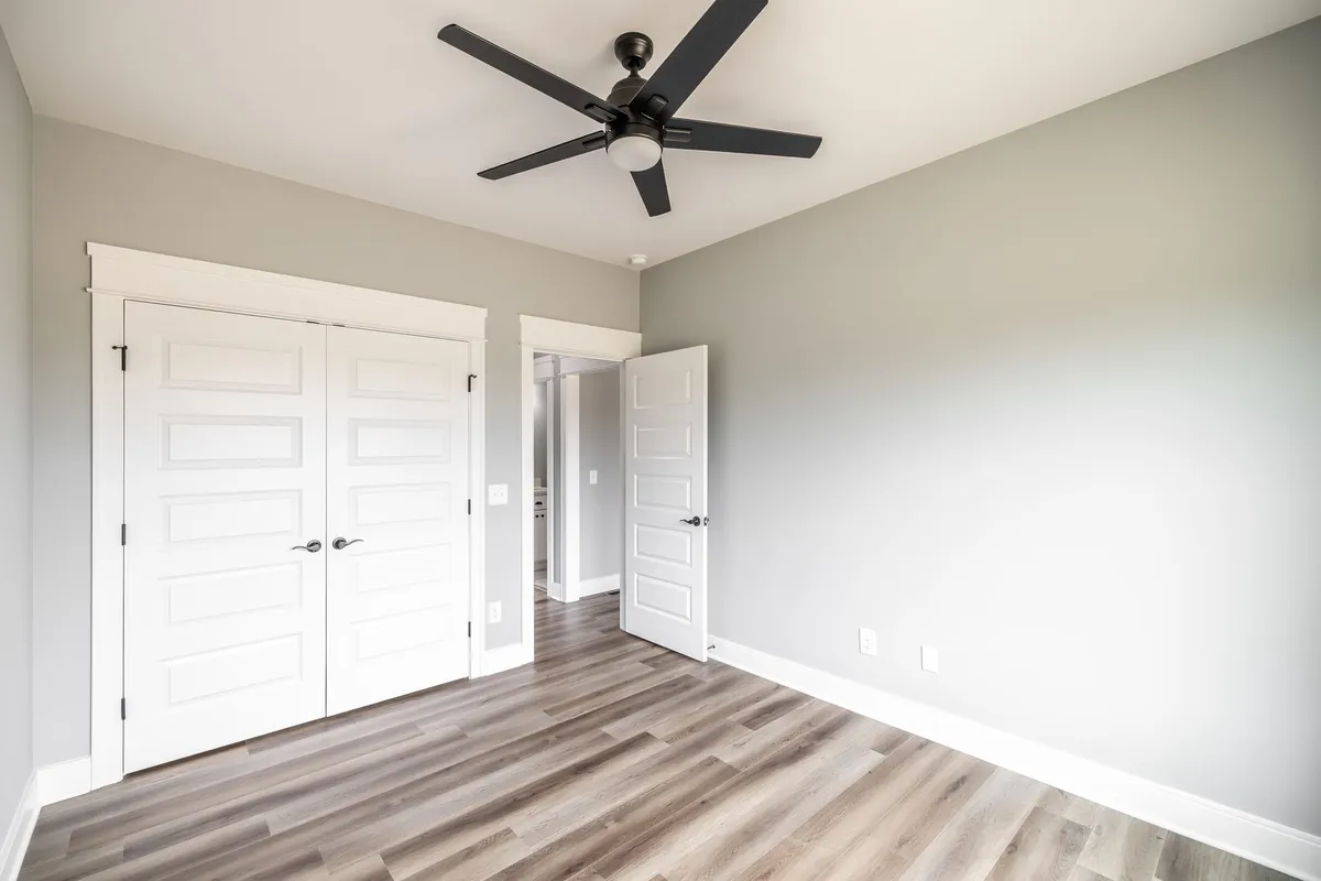 Second bedroom with ceiling fan and a double closet at 1200 Vickie Ln