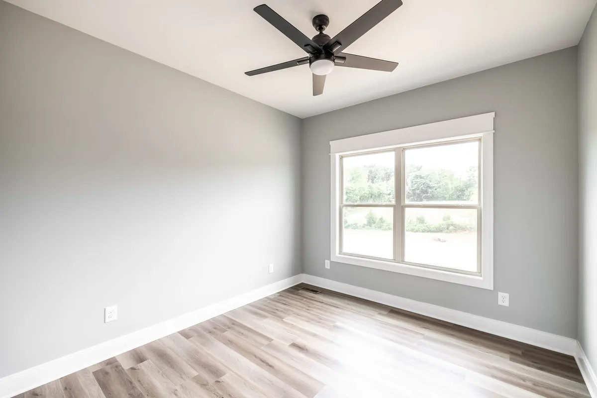 Third bedroom with ceiling fan and natural light at 1200 Vickie Ln