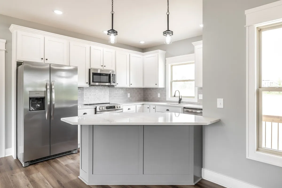 Kitchen with white cabinetry, stainless appliances and a center island at 1200 Vickie Ln