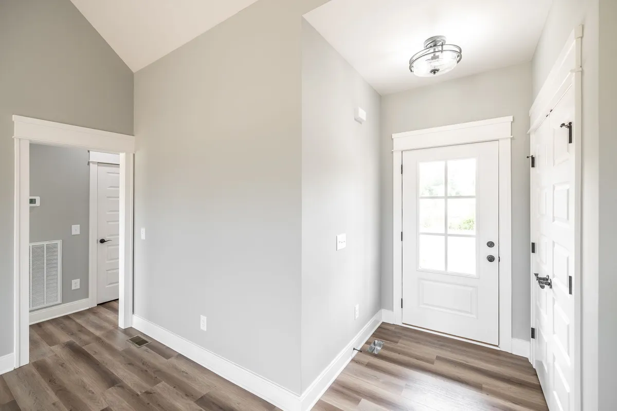 Open great room with vaulted ceiling and laminate wood floors at 1200 Vickie Ln