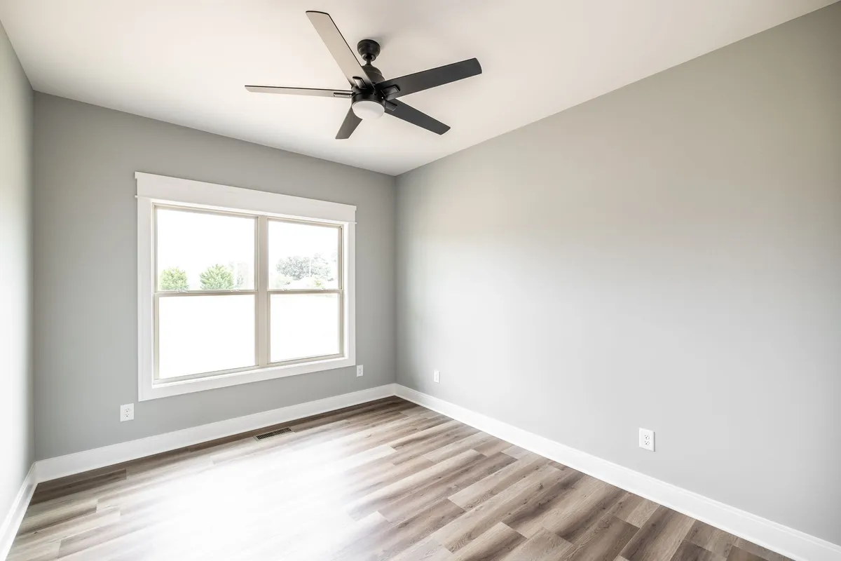 Primary bedroom with ceiling fan and laminate flooring at 1200 Vickie Ln