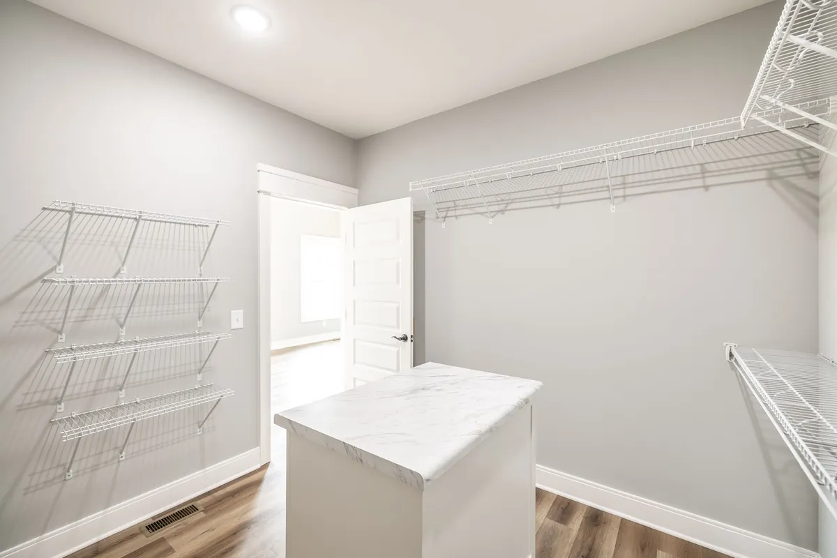 Walk-in closet with built-in shelving and a center island at 1200 Vickie Ln