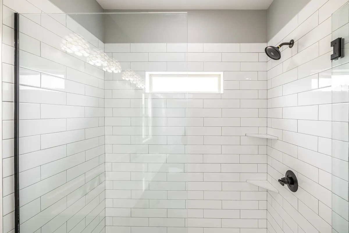 Tiled walk-in shower in the primary bath at 1200 Vickie Ln