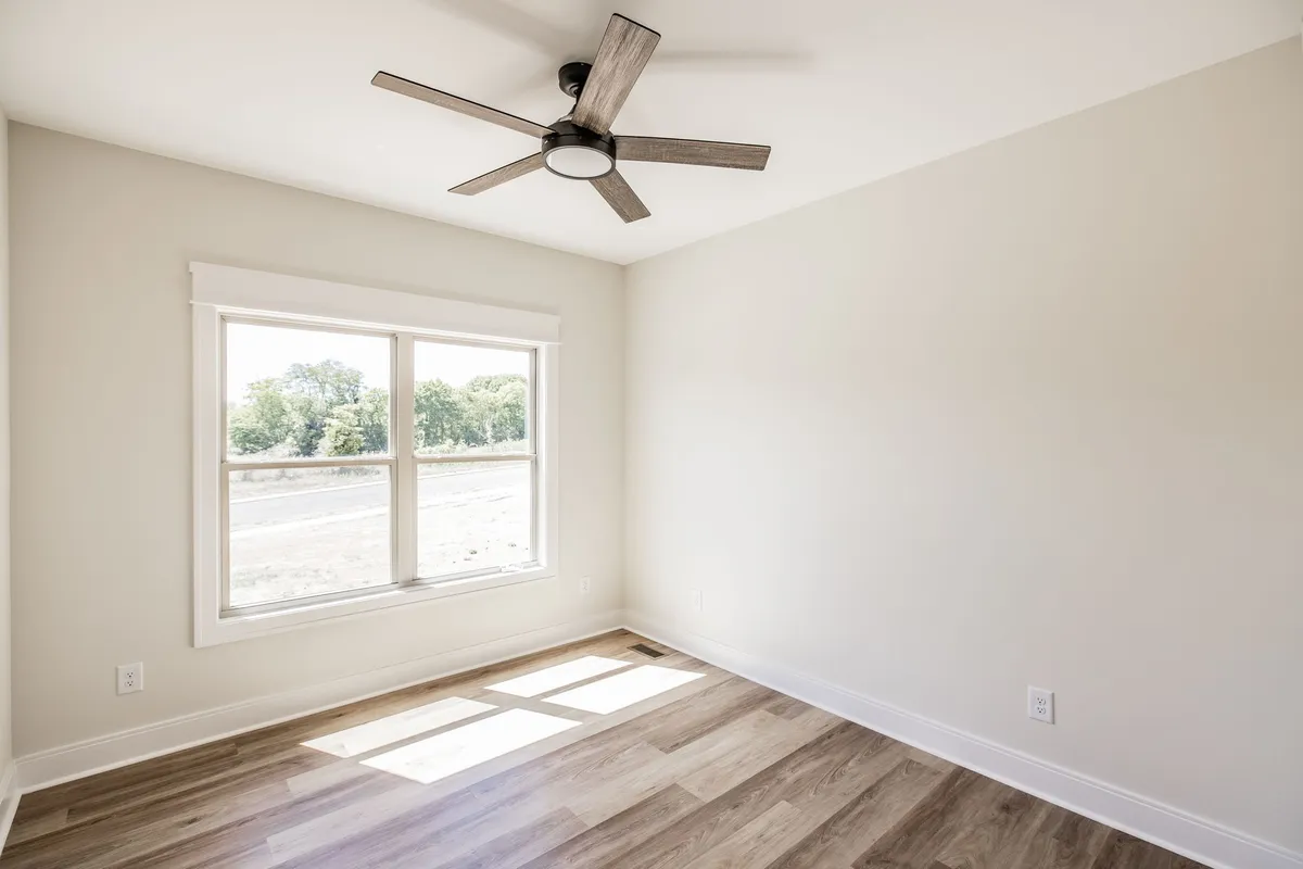 Second bedroom with ceiling fan and laminate wood flooring at 1204 Vickie Ln