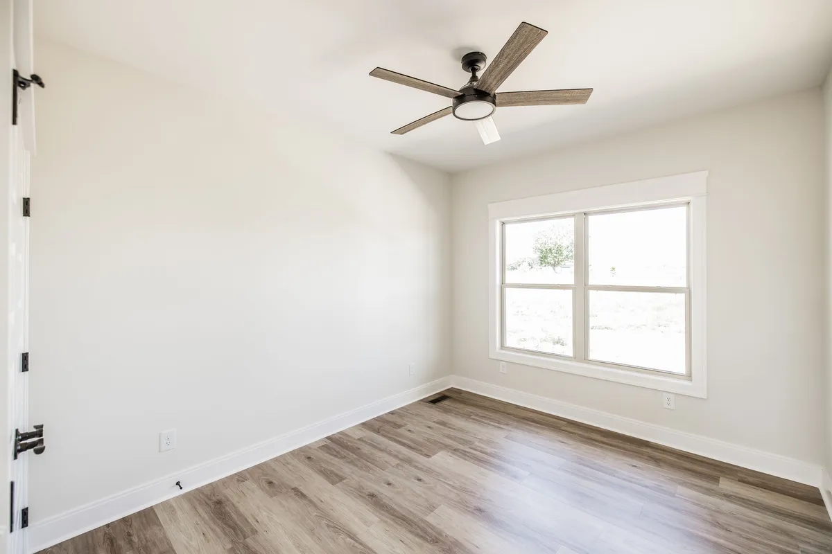 Third bedroom with ceiling fan and natural light at 1204 Vickie Ln