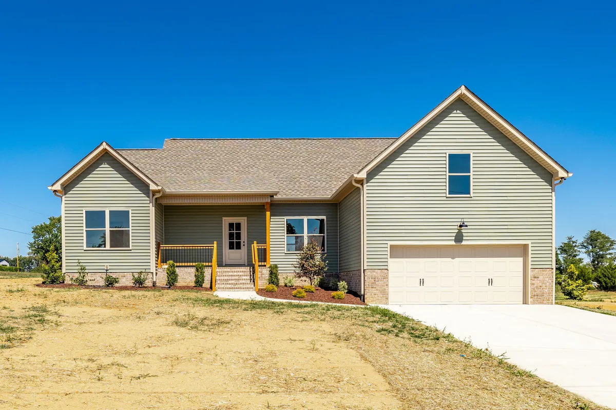 Front exterior of 1204 Vickie Ln, a new-construction home with a two-car garage on a 1-acre lot in Portland TN