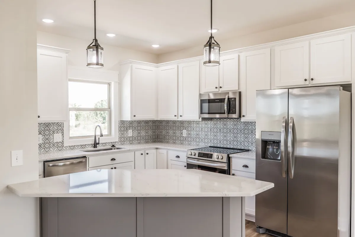 Kitchen with white cabinetry, stainless appliances and a center island at 1204 Vickie Ln