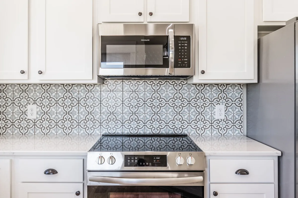 Stainless range with patterned tile backsplash at 1204 Vickie Ln