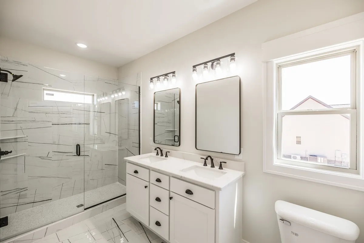 Primary bathroom with double vanity and tile flooring at 1204 Vickie Ln