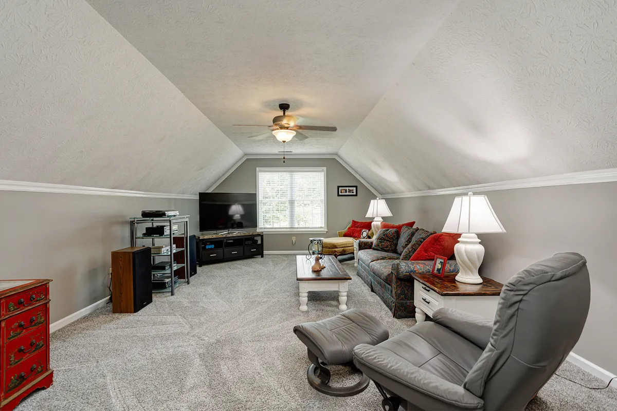 Large bonus room over the garage with a vaulted ceiling at 129 Baldridge Dr