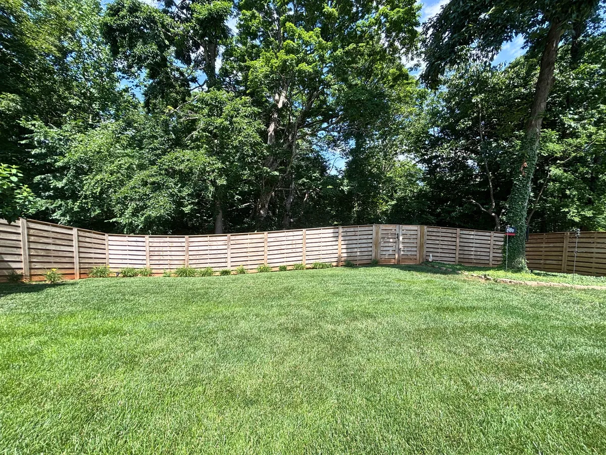 Spacious fenced backyard on nearly an acre at 129 Baldridge Dr
