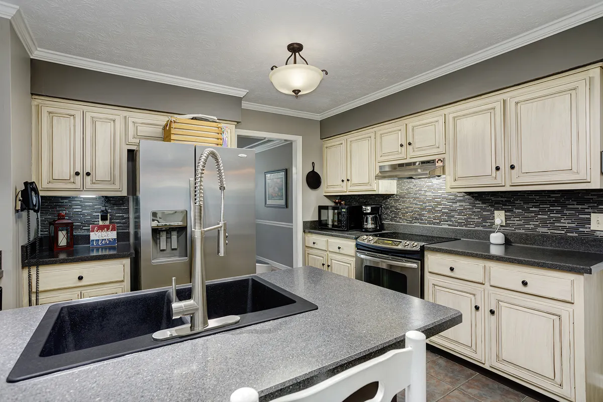 Kitchen with a stainless refrigerator and white cabinetry at 129 Baldridge Dr