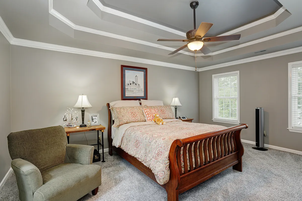 Primary bedroom with a tray ceiling and ceiling fan at 129 Baldridge Dr