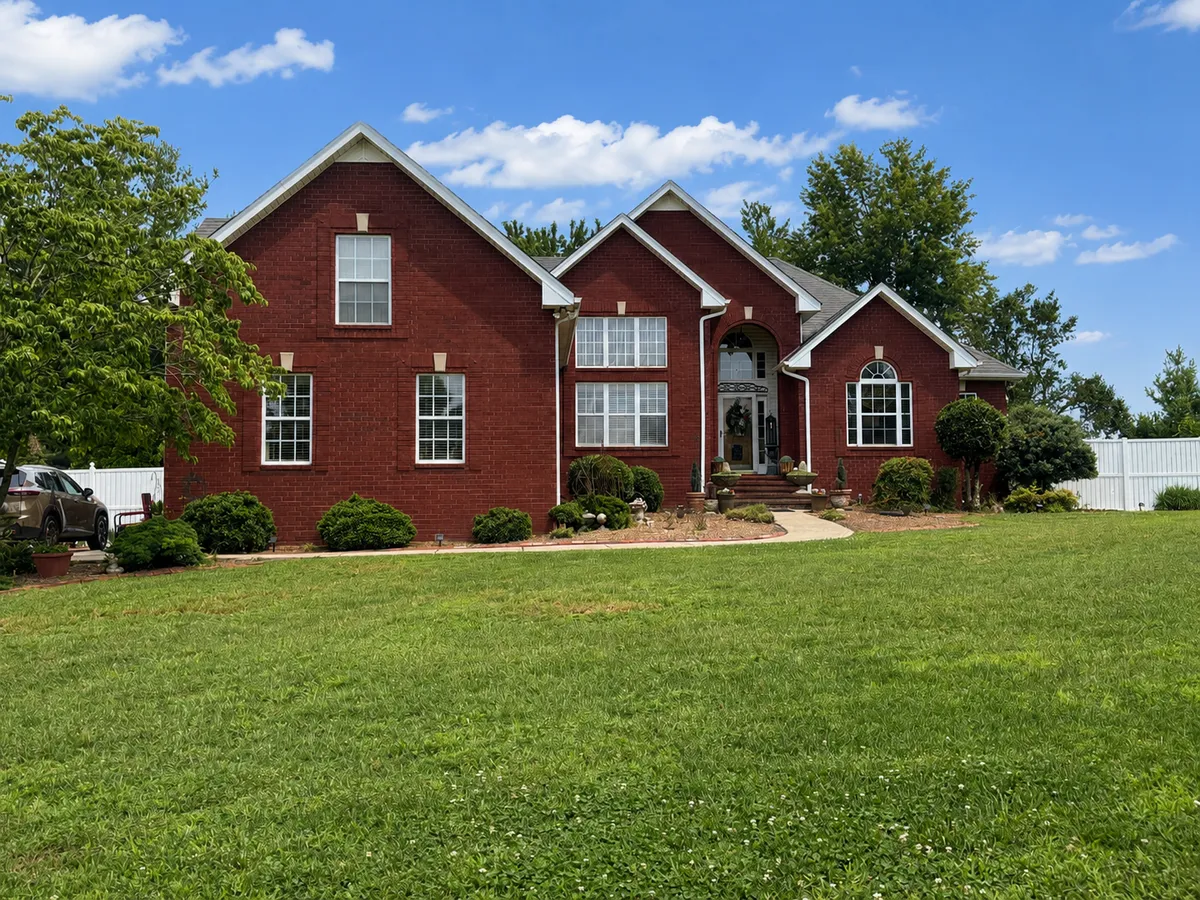 Front exterior of 319 Cherry Ln, a large all-brick two-story home in White House TN