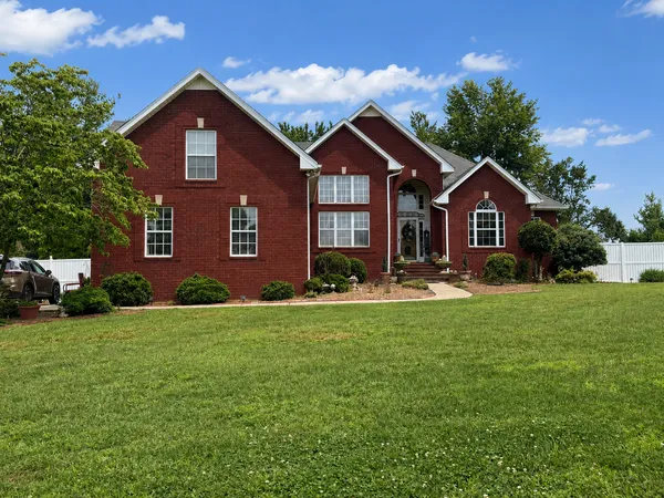 Front exterior of 319 Cherry Ln, a large all-brick two-story home in White House TN