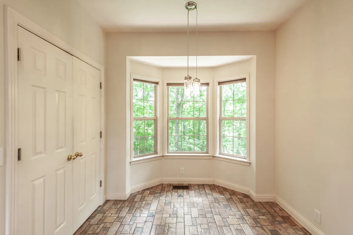 Bay-window breakfast nook with wooded views at 6513 N Mount Pleasant Rd