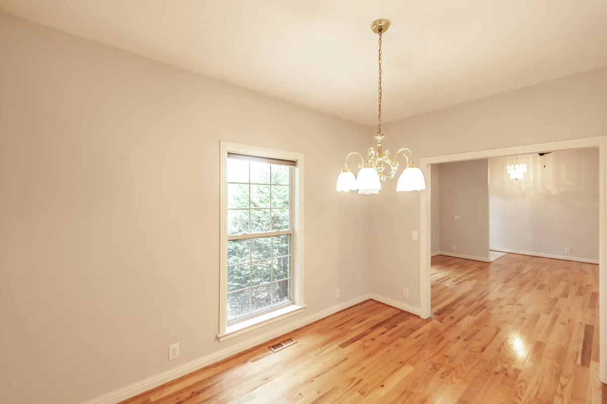 Dining room with hardwood floors and a chandelier at 6513 N Mount Pleasant Rd