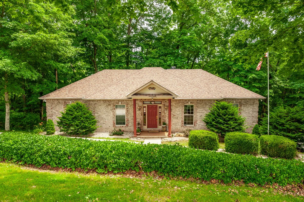 Front exterior of 6513 N Mount Pleasant Rd, an all-brick ranch on a private wooded lot in Greenbrier TN