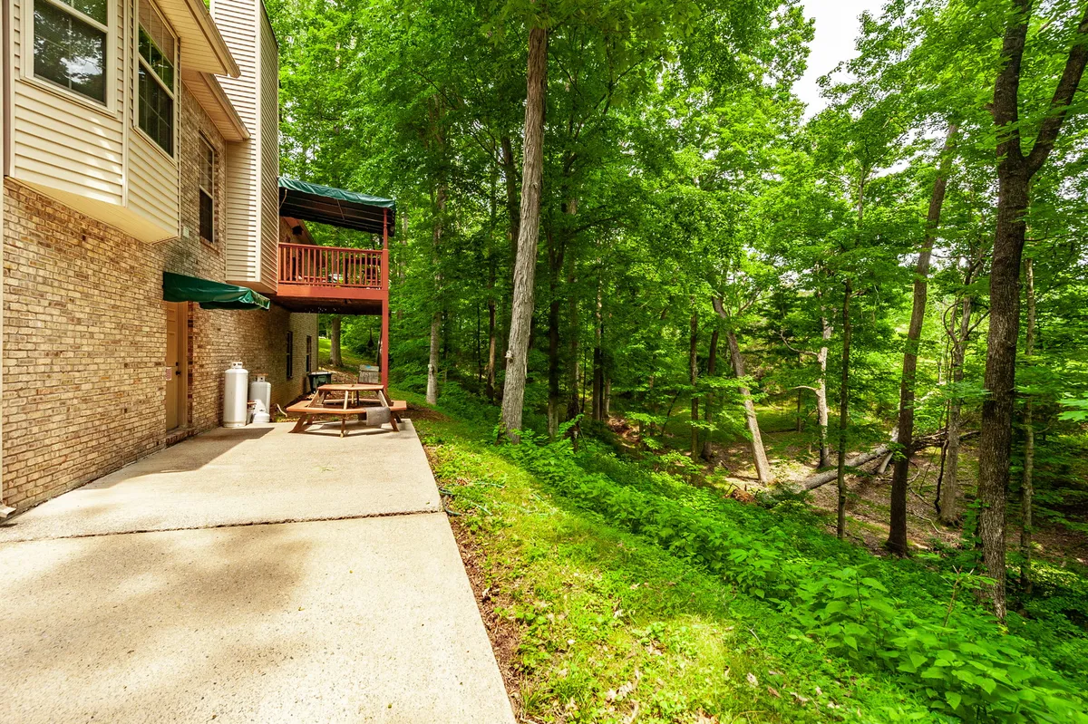Rear exterior with an elevated deck and walkout basement on the wooded 1.24-acre lot at 6513 N Mount Pleasant Rd
