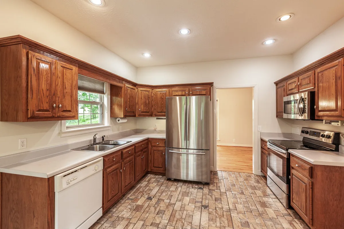 Kitchen with wood cabinetry and stainless appliances at 6513 N Mount Pleasant Rd