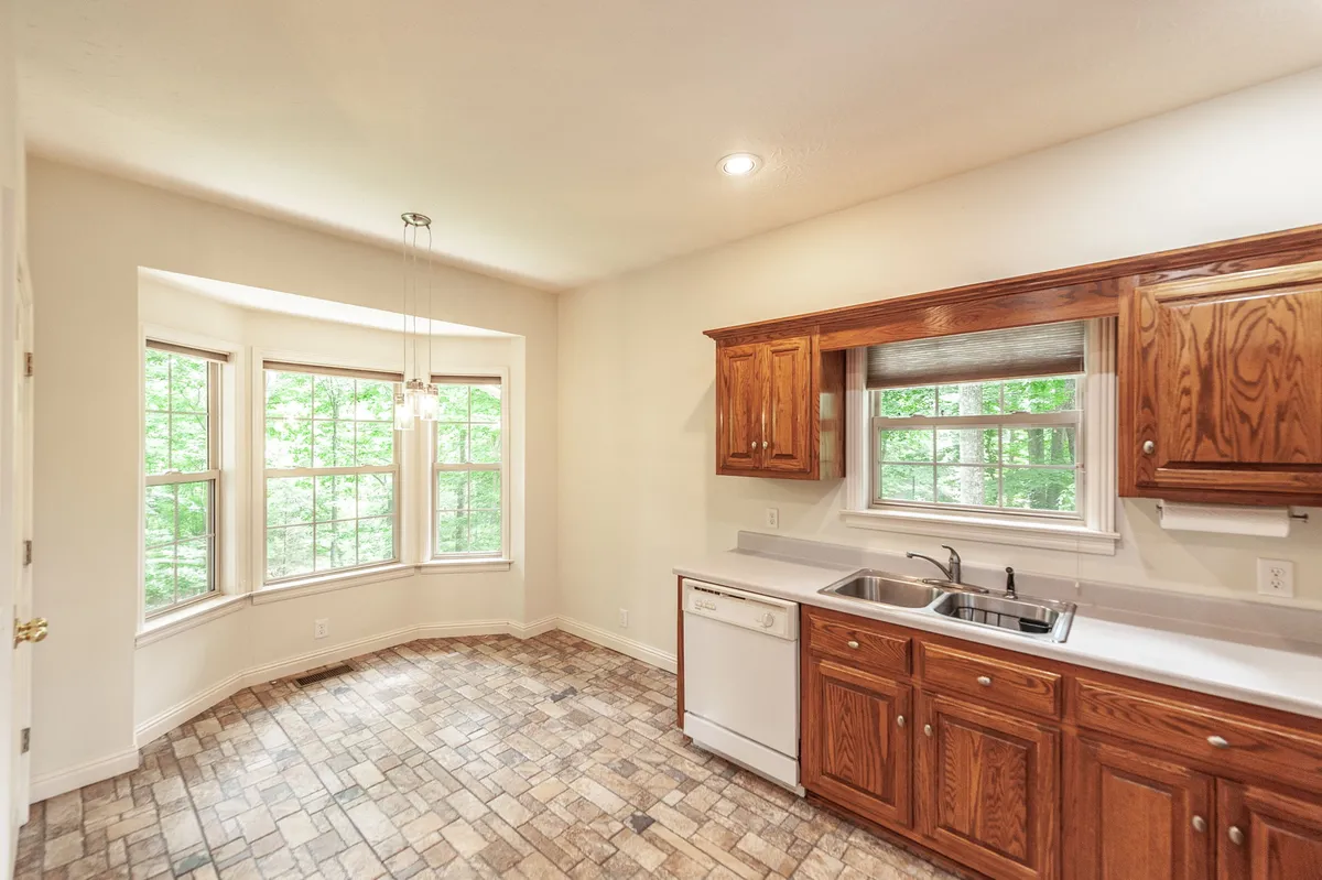Kitchen sink with a window over the wooded backyard at 6513 N Mount Pleasant Rd