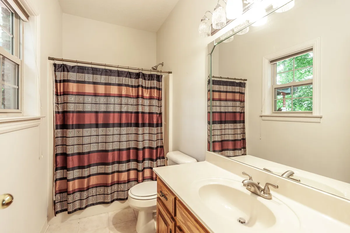 Primary bathroom with a double vanity and soaking tub at 6513 N Mount Pleasant Rd